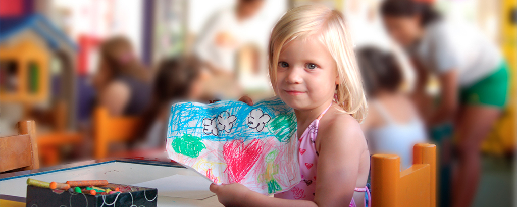 kid with a colour pencil drawn heart